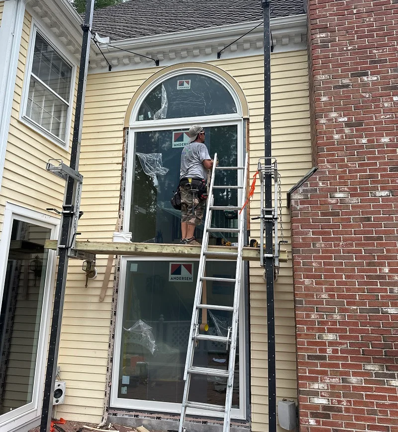 Custom exterior trim around the Andersen circle top window
